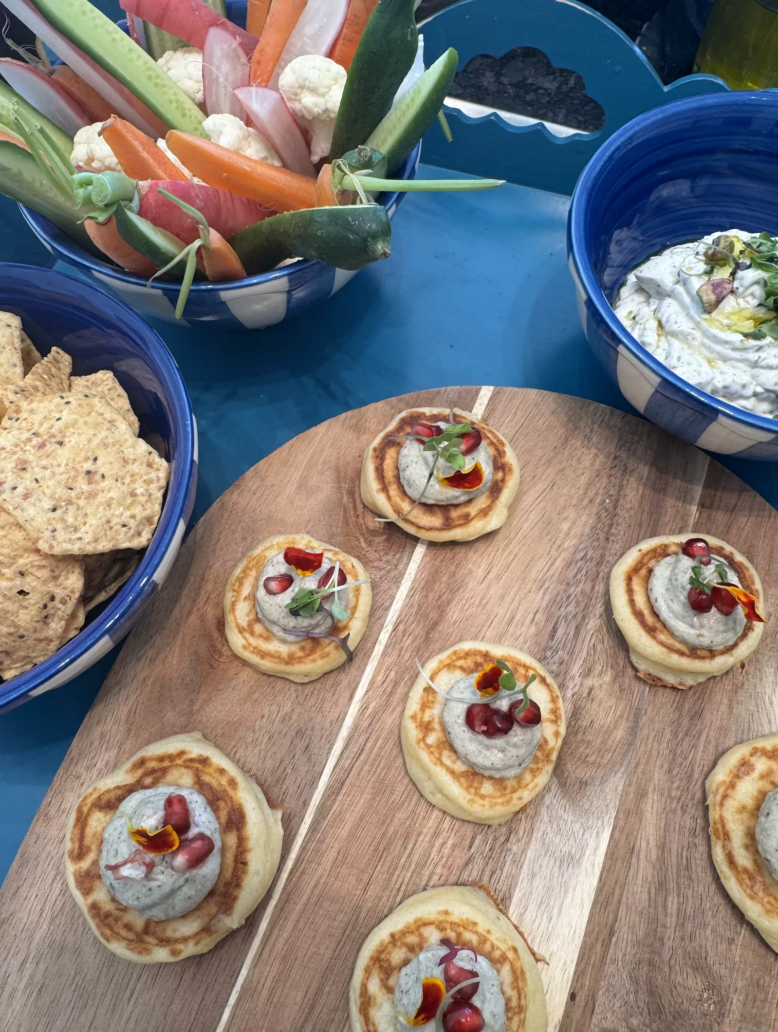 Homemade blinis with fish roe and fresh vegetable crudités with hummus for Marbella sunset aperitivo
