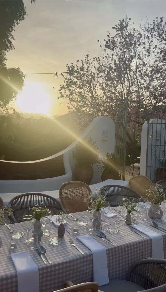 Elegant sunset dinner table setup Marbella beachfront with Mediterranean sea view and golden hour lighting