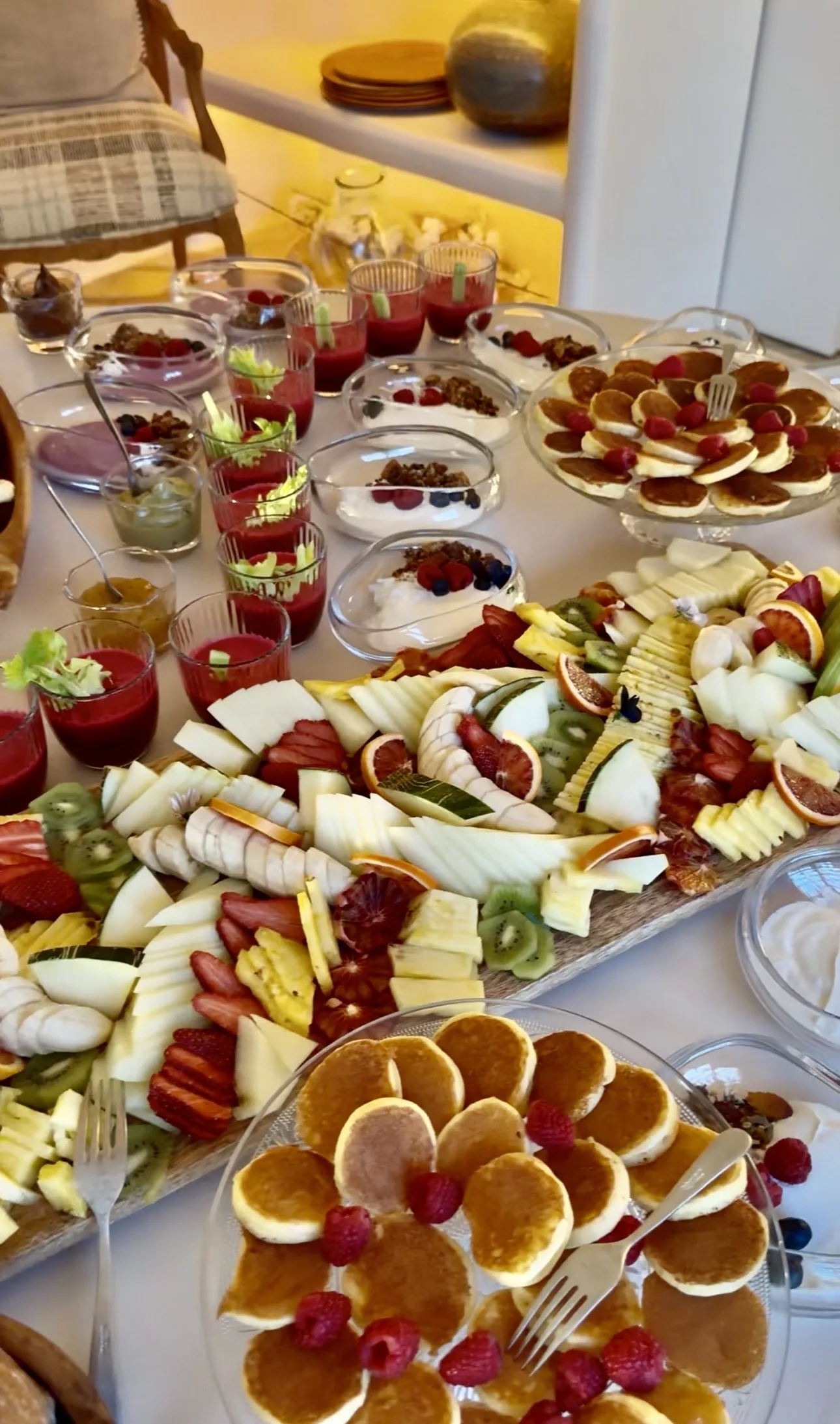 Brunch catering table with fresh fruit platter, mini pancakes, smoothies and yogurt bowls at a private villa in Marbella by Campo