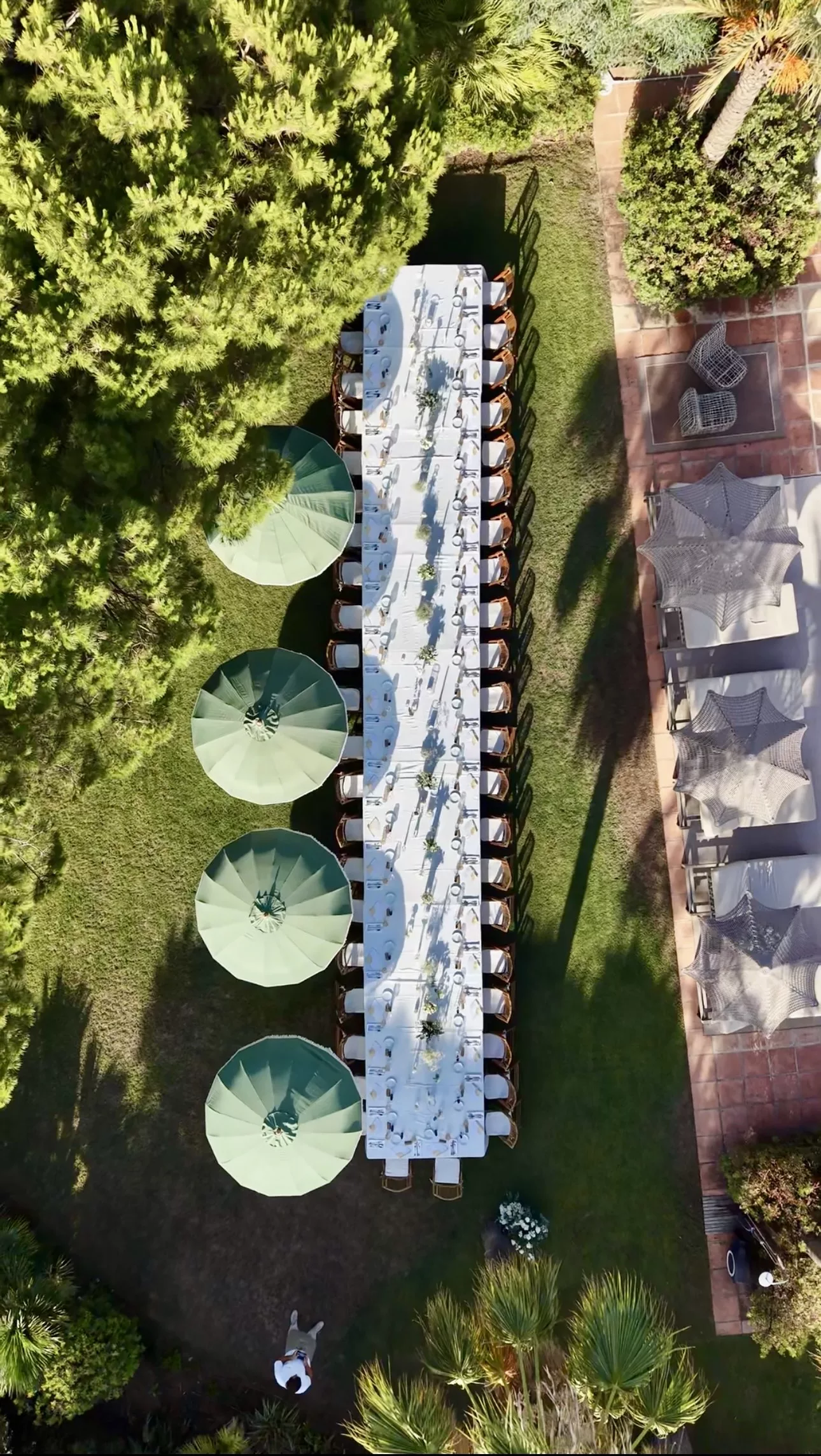 Aerial drone view of Campo Marbella wedding banquet table set in a private garden, Costa del Sol