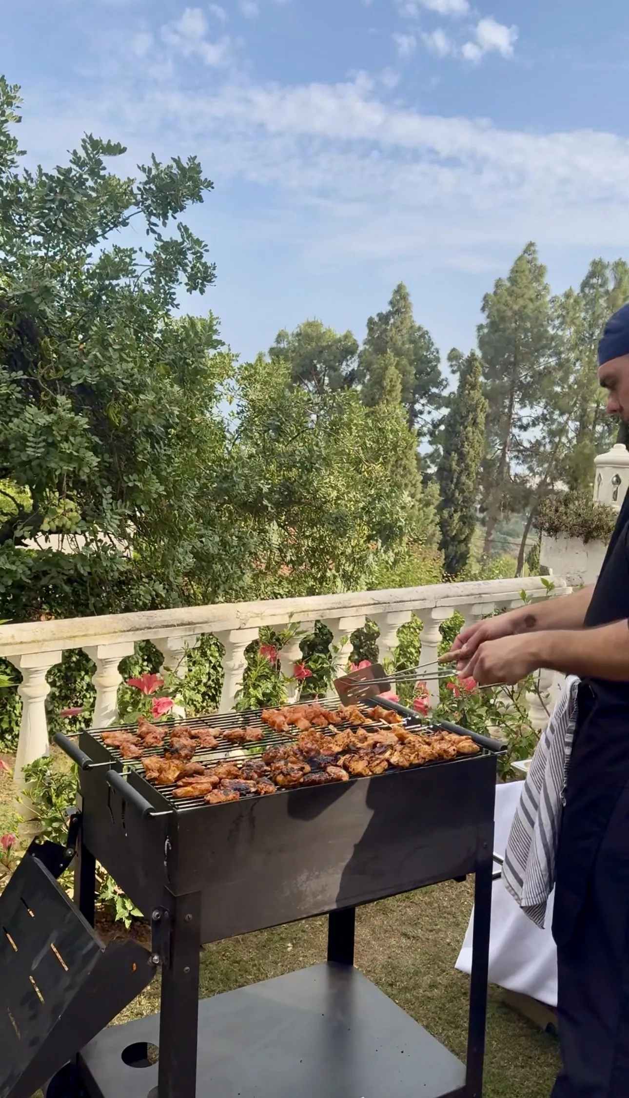 Campo Marbella chef grilling lamb skewers on live fire BBQ at a Costa del Sol wedding