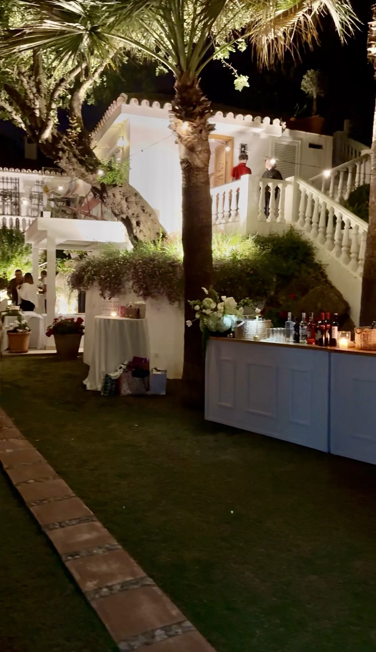 Outdoor evening bar illuminated at night at a Campo Marbella wedding in a private garden