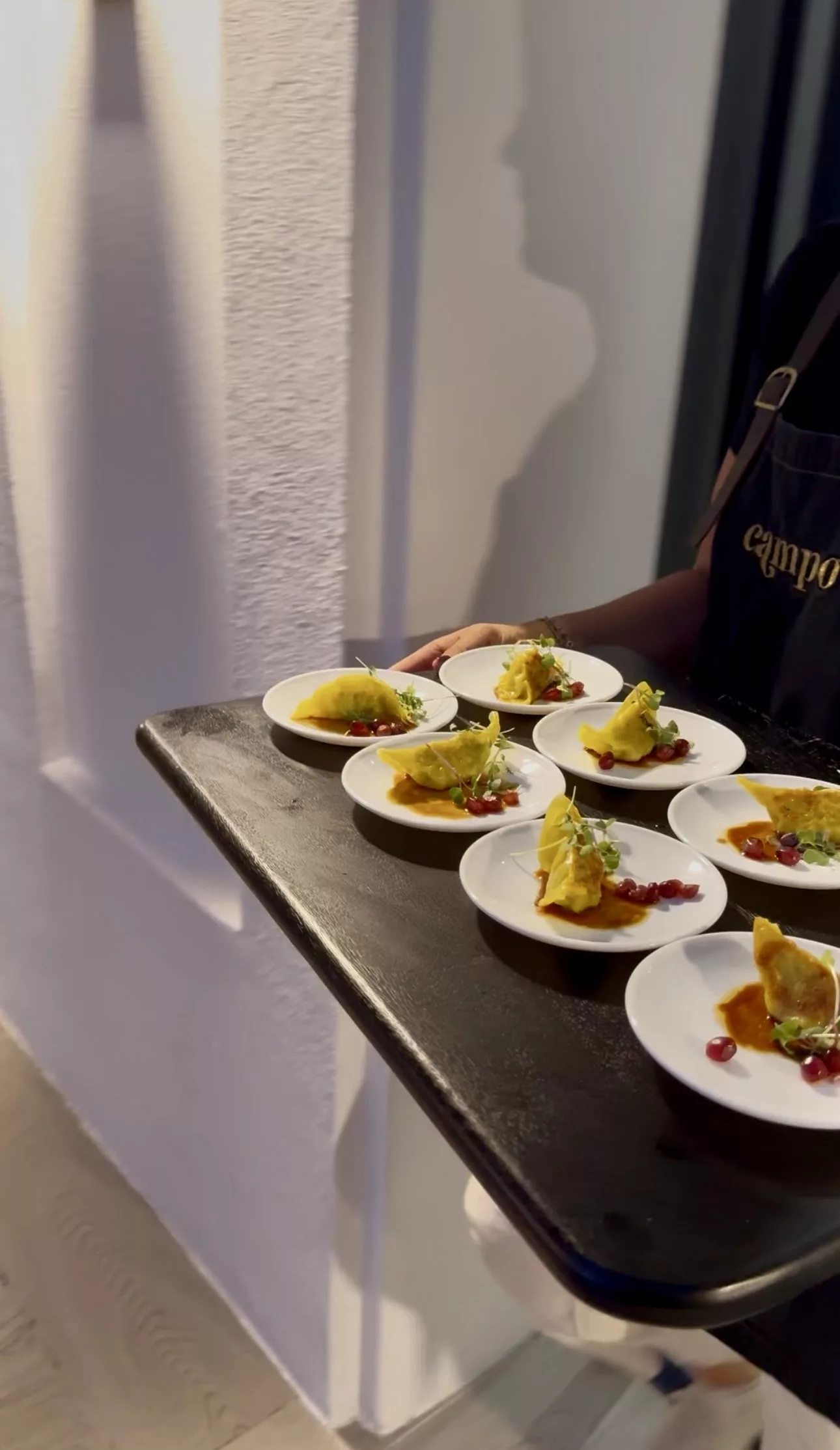 Amuse-bouche canapés with pomegranate served on a tray at a Campo corporate cocktail event in Marbella