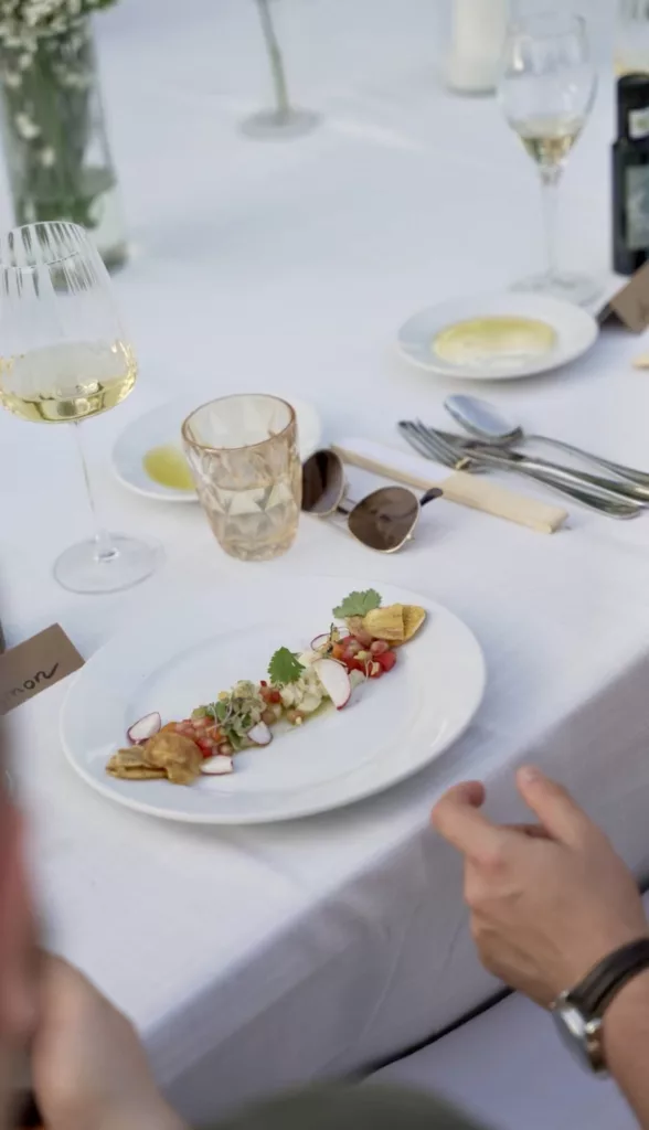 Wedding table setting with a starter plate, wine glass and cutlery on white linen in Marbella