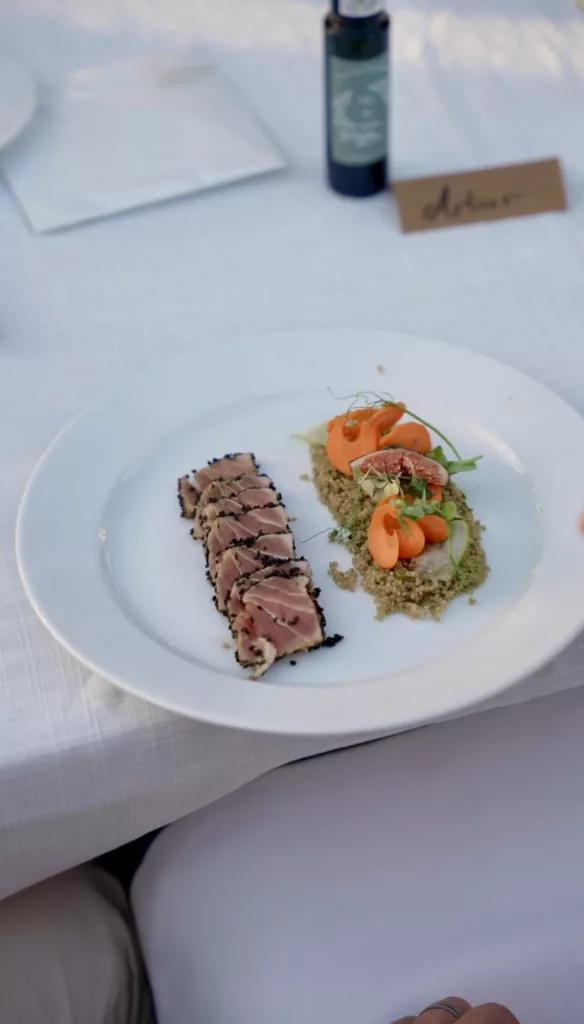 Seared tuna tataki with quinoa and carrot on a white plate at a seated wedding dinner in Marbella